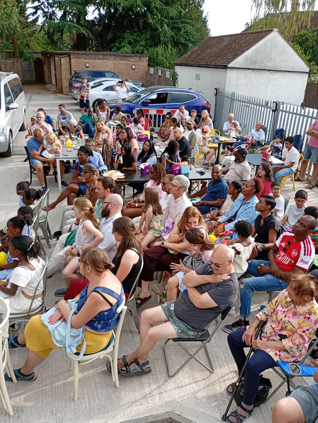 Families and friends seated in the audience at Mia IV Deli.