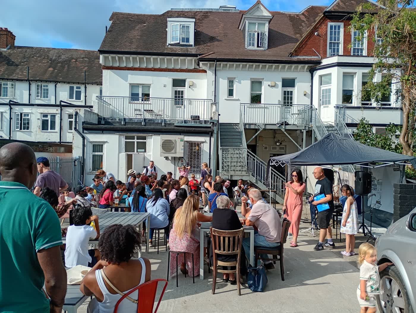 Guests gathered around tables in the courtyard at Mia IV Deli.