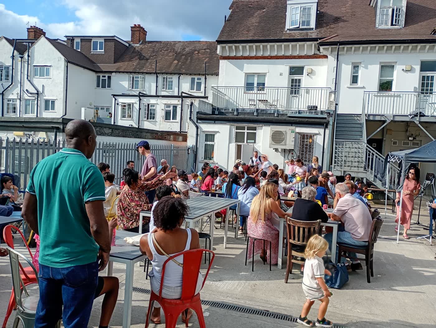Families enjoying the summer afternoon before the performances begin.