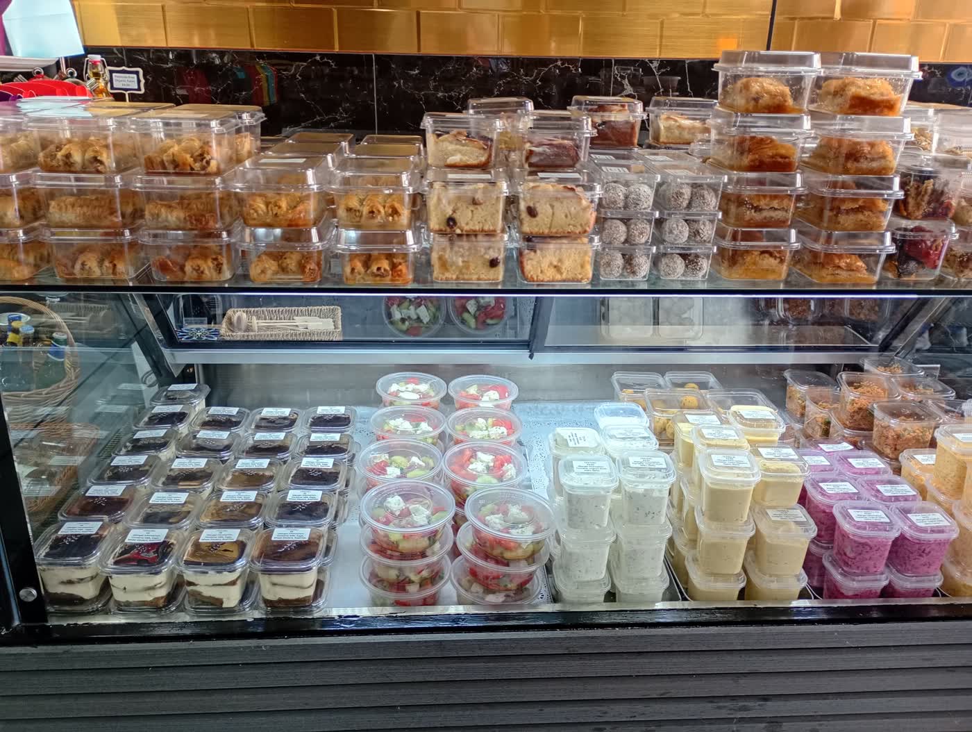 The Mia IV Deli counter laid out with cakes and salads for the evening.